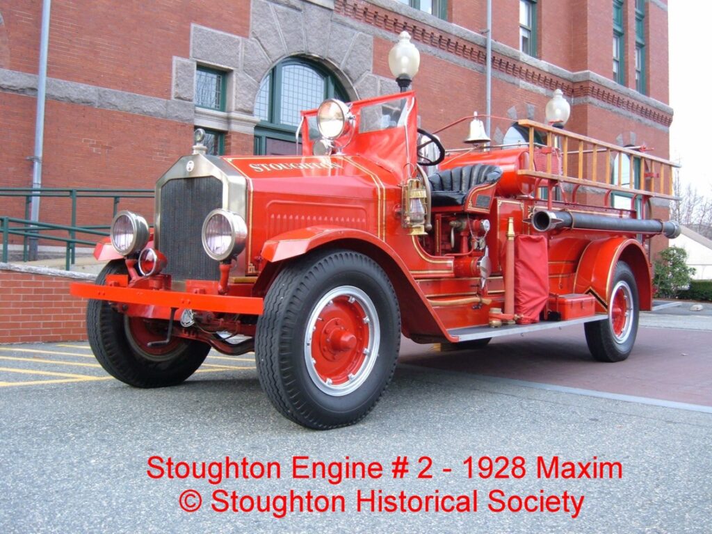 Engine 2 1928 Maxim Fire Truck in front of the Great Hall of Stoughton.